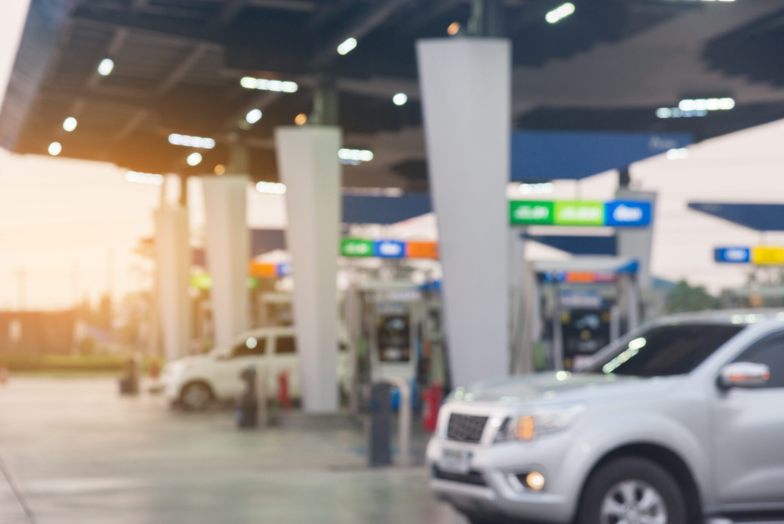 Cars lined up at convenience store gas station pumps