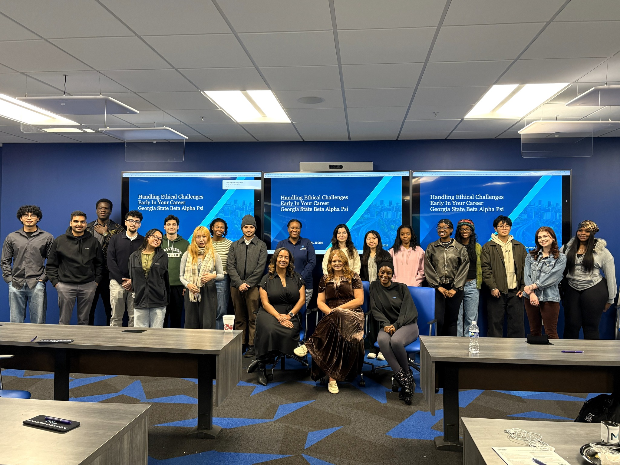 Moore Colson professionals standing and smiling after speaking to the National Association of Black Accountants (NABA).