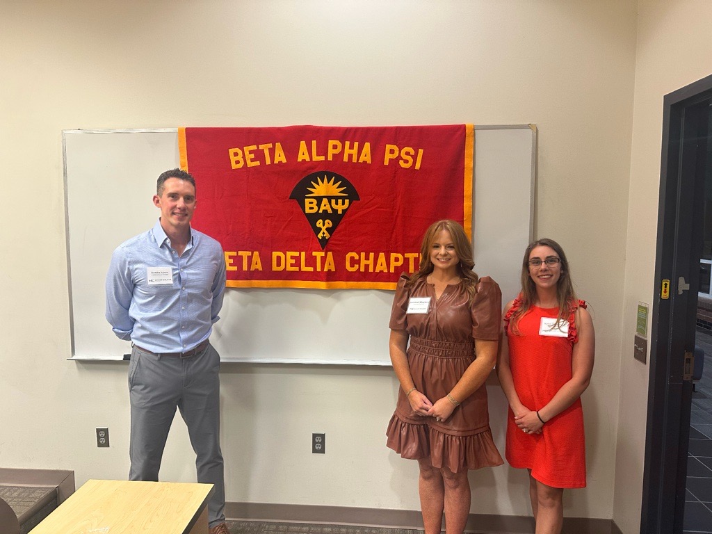 Moore Colson professionals standing and smiling after speaking to the Beta Alpha Psi chapter.