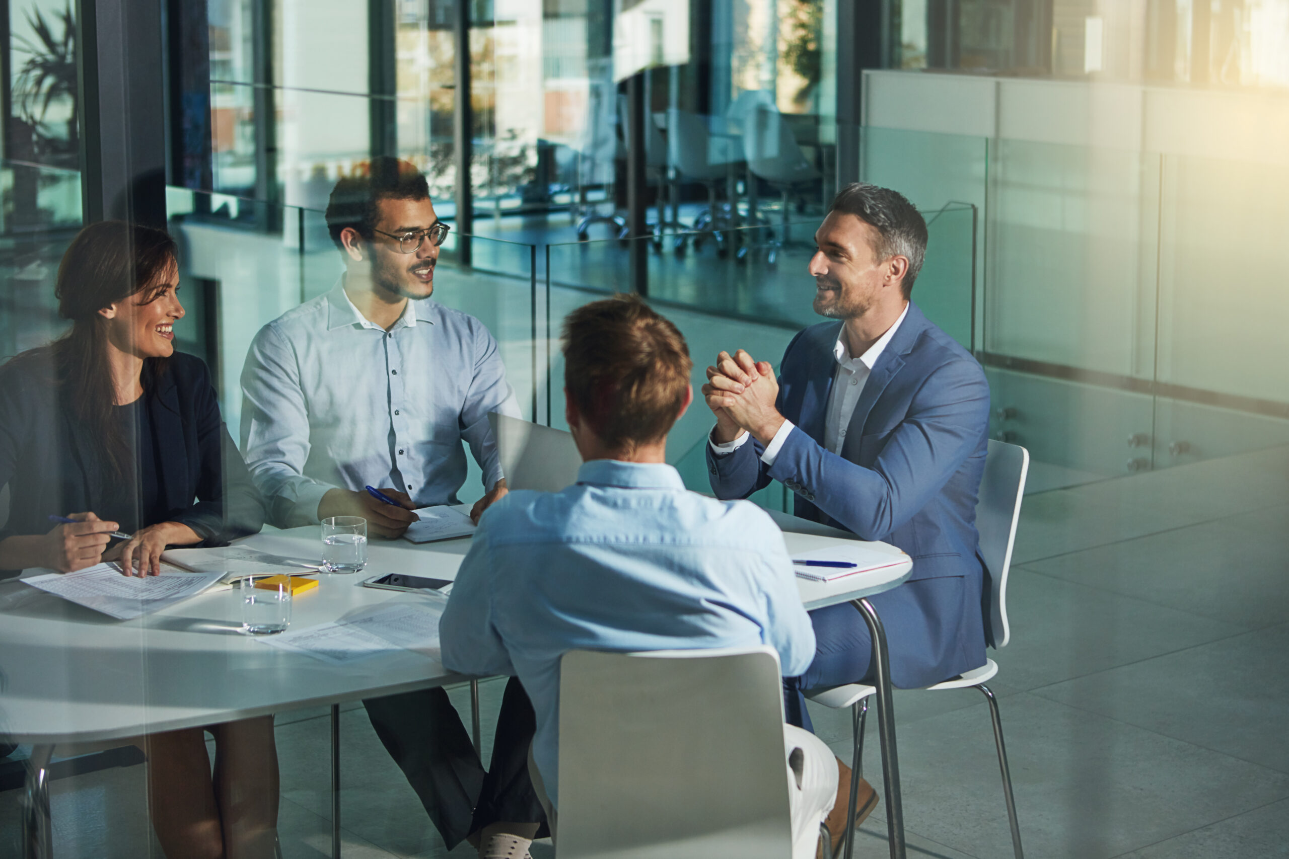 Business valuation advisors sitting at a table having a meeting with a client.
